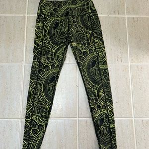 CVG black leggings with neon green pattern.